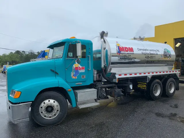 A blue truck with a container on the back