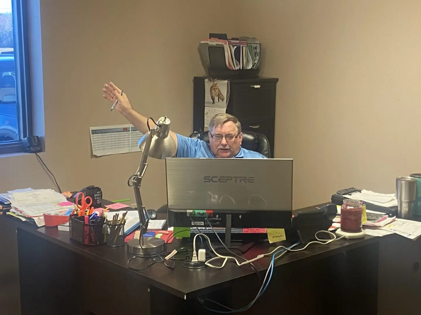 A man sitting at his desk with a laptop.