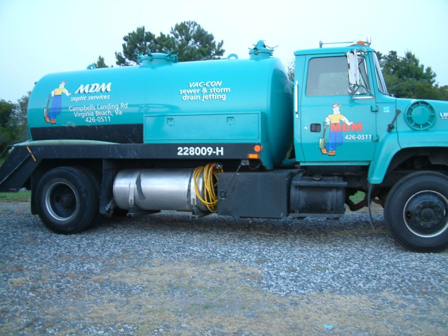 A blue truck is parked on the side of the road.